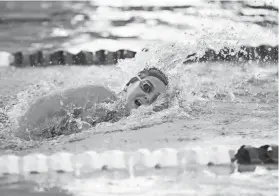  ?? SARAH PHIPPS/THE OKLAHOMAN ?? Shawnee’s Piper McNeil swims in the 100-yard freestyle in the Class 5A state finals Saturday at Edmond Schools Aquatic Center.