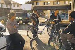  ?? Paul Kuroda / Special to The Chronicle ?? People gather near where a 39yearold man was killed and two other people were wounded in a shooting Thursday on 89th Avenue.