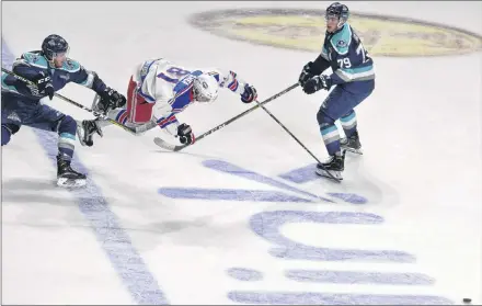  ?? JASON SIMMONDS/JOURNAL PIONEER ?? Summerside Western Capitals forward TJ Shea is upended as he is unable to work his way through the Edmundston Blizzard’s Nicholas Richards, left, and Keenan Gillis at the offensive blue-line in the second period of Saturday night’s MHL (Maritime Junior Hockey League) game at Eastlink Arena on Saturday night. Shea recorded three points to lead the Caps to a 4-2 come-from-behind win.