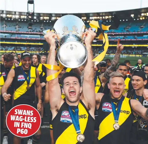  ??  ?? JUBILATION: Scenes like this one – of Tigers’ captain Trent Cotchin and teammates celebratin­g their 2019 AFL Grand Final win over the GWS Giants – could play out at the Gabba, or Perth, depending on the AFL’s decision on the big game’s location. Picture: GETTY IMAGES