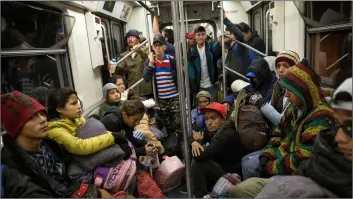  ?? AP Photo/RodRIgo Abd ?? Central American migrants ride on the subway after leaving the temporary shelter at the Jesus Martinez stadium, in Mexico City, on Friday.