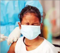  ?? HONG MENEA ?? A girl gets vaccinated in Phnom Penh’s Chroy Changvar district.