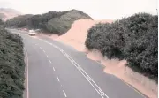  ??  ?? PROVINCIAL Department of Transport teams regularly clear sand off the M4 highway near othongathi, but a more permanent solution is needed.