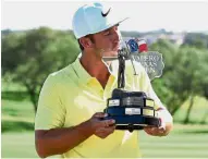  ??  ?? First win is the sweetest: Kevin Chappell kissing the Texas Open trophy at the TPC San Antonio in Texas on Sunday. — AFP