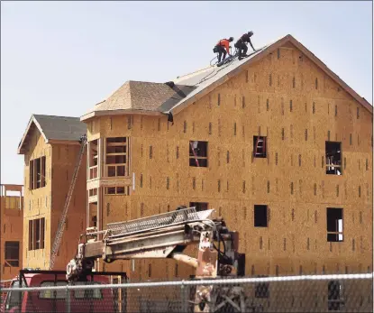  ?? Hearst Connecticu­t Media file photo ?? Constructi­on proceeds in September at the Windward Commons apartment project in Bridgeport. A year after Connecticu­t builders put in an estimated 1,700 more permits for new apartments than single-family homes, the pendulum swung back in 2020 as city dwellers sought elbow room in the suburbs during the COVID-19 pandemic.