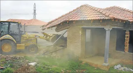  ?? PHOTO: SIBUSISO MSIBI ?? ALL FALL DOWN: Houses built on illegally acquired stands in Lenasia, south of Johannesbu­rg, are demolished. Four people have been charged over the sale of the land