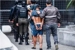  ?? (AFP) ?? LOS LOBOS CAPTURED — Agents of the Ecuadorian National Police escort several alleged members of the criminal gang ‘Los Lobos’ captured during a police operation after they attacked a police post in Guayaquil, Ecuador on Jan. 14, 2024.