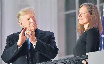  ?? AFP ?? US President Donald Trump applauds Judge Amy Coney Barrett after she was sworn in as a Supreme Court associate justice.