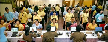  ??  ?? People queue to register as king’s volunteers at the Bureau of the Royal Household in Bangkok. — Reuters photos
