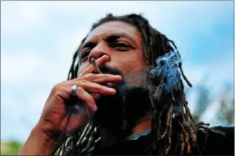  ?? FILE PHOTO ?? Ed Forchion also known as NJ Weedman, takes a drag at a Legalize Marijuana March in Trenton in 2014.