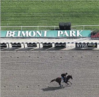  ?? AL BELLO GETTY IMAGES ?? Triple Crown contender Justify trains with Humberto Gomez prior to the 150th running of the Belmont Stakes at Belmont Park.