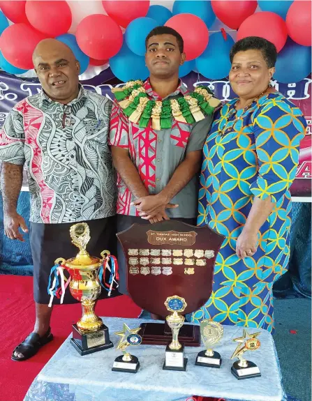  ?? Nicolette Chambers ?? Saint Thomas High School Dux, Isireli Iosefo Mataitoga alongside his dad, Ananaisa and mum, Akata with his awards at the school in Lautoka on November 18, 2022. Photo: