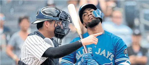  ?? JULIO CORTEZ/THE ASSOCIATED PRESS ?? Saturday’s game ended with Blue Jay Teoscar Hernandez’s bat on his shoulder after striking out for the third time against Kyle Higashioka and the Yankees.