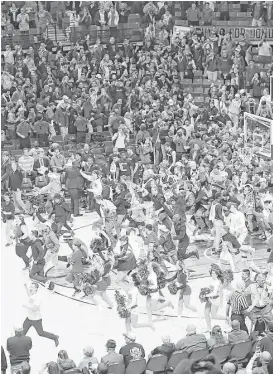  ?? John Weast / Getty Images ?? Beating the fourth-ranked team in the nation prompts a court storming in Lubbock on Monday night.