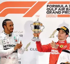  ??  ?? Ferrari’s Monegasque driver Charles Leclerc (R) celebrates on the podium after placing third at the Formula One Bahrain Grand Prix next to Mercedes’ British driver Lewis Hamilton (first placed) at the Sakhir circuit in the desert south of the Bahraini capital. - AFP photo