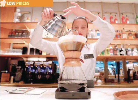  ?? — Reuters ?? An employee prepares a coffee inside the new Starbucks Reserve Roastery flagship in downtown Milan, Italy.