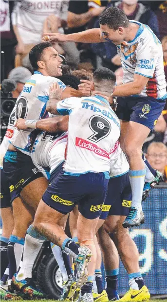  ?? Picture: BRADLEY KANARIS ?? Gold Coast players celebrate the dramatic late try to Konrad Hurrell that sealed an incredible win for the Titans against the Melbourne Storm at Suncorp Stadium last night