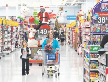  ?? David J. Phillip / Associated Press 2018 ?? Shoppers like these at a Houston Walmart helped push the world’s largest retailer’s financial results higher for the fourth quarter, which included the crucial holiday shopping period.