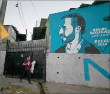  ?? ?? A man walks past a mural depicting El Salvador’s President and candidate for re-election for the Nuevas Ideas party, Nayib Bukele, in Mejicanos, San Salvador. — AFP photo