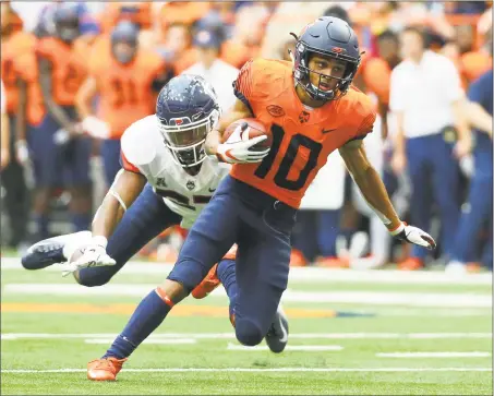  ?? Rich Barnes / Getty Images ?? Syracuse’s Sean Riley runs with the ball after a catch in front of UConn’s Omar Fortt on Saturday.