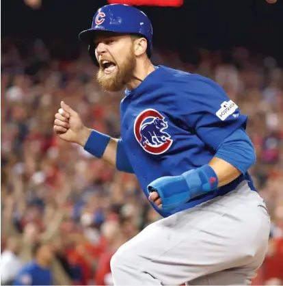  ??  ?? Ben Zobrist celebrates while scoring on a two- run double by Addison Russell during the Cubs’ four- run fifth inning Thursday. | AP