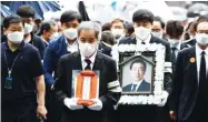  ??  ?? CHUNG SUNG-JUN/GETTY IMAGES Mourners attend the funeral service in South Korea of Seoul Mayor Park Won-soon on July 13, 2020.
