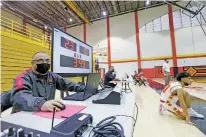  ?? LUIS SÁNCHEZ SATURNO/THE NEW MEXICAN ?? Robbie Garcia of Española Valley High works the temporary scoreboard Tuesday.