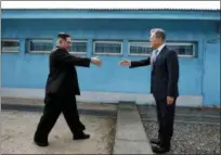  ?? KOREA SUMMIT PRESS POOL VIA THE ASSOCIATED PRESS ?? North Korean leader Kim Jong Un, left, prepares to shake hands with South Korean President Moon Jae-in at the border village of Panmunjom in the Demilitari­zed Zone on Friday. Their discussion­s will be expected to focus on whether the North can be...