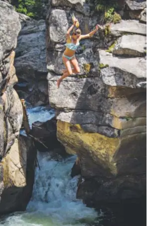  ??  ?? A woman jumps into the Devil’s Punchbowl on the Roaring Fork River.
Provided by Aspen Chamber Resort Associatio­n