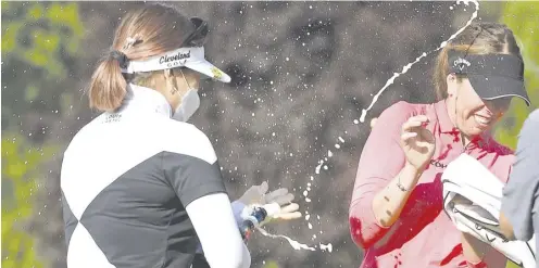  ?? STEVE DYKES/AGENCE FRANCE-PRESSE ?? HANNAH Green sprays champagne over Georgia Hall after winning the the Cambia Portland Classic on the second playoff hole at Columbia Edgewater Country Club.