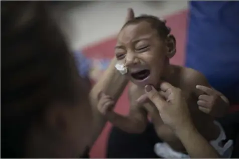  ?? FELIPE DANA— ASSOCIATED PRESS FILE ?? In this Sept. 28, 2016file photo, Jose Wesley Campos, who was born with microcepha­ly, cries during a physical therapy session at the AACD rehabilita­tion center in Recife, Brazil. The Zika virus may not seem as big a threat as last summer but don’t let...