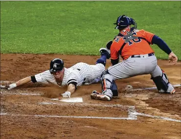  ?? CHANG W. LEE / THE NEW YORK TIMES ?? The Yankees’ Brett Gardner beats the tag of Astros catcher Brian McCann to score from first base on Aaron Judge’s double down the left-field line in the third inning of Wednesday’s Game 5 of the ALCS.