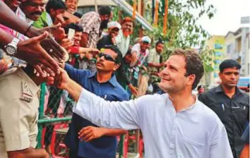  ?? PTI ?? Congress party president Rahul Gandhi greets supporters, during an election campaign rally, ahead of the Karnataka Assembly Elections in Bengaluru yesterday.