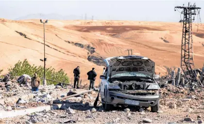  ?? Photo / AP ?? People inspect a site damaged by Turkish airstrikes that hit an electricit­y station in Syria.