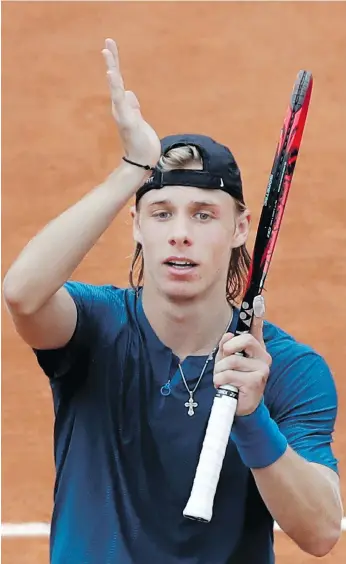  ?? ALESSANDRA TARANTINO/THE ASSOCIATED PRESS ?? Denis Shapovalov celebrates after battling back from a slow start to win his first-round match against Australia’s John Millman at the French Open in Paris on Tuesday.