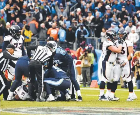  ??  ?? Broncos tight end A.J. Derby is consoled by center Matt Paradis after getting the ball stripped by Tennessee Titans inside linebacker Avery Williamson for a fumble after his catch late in the fourth quarter Sunday. John Leyba, The Denver Post