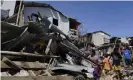  ?? Photograph: Jay Labra/AP ?? Residents salvage parts of their homes damaged from typhoon Rai in Talisay, Cebu province.