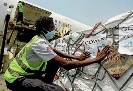  ?? AP ?? Airport workers unload a shipment of Covid-19 vaccines distribute­d by the Covax Facility in Ivory Coast’s capital, Abidjan. Ivory Coast is the second country to benefit from the United Nations-backed initiative to ensure that low- and middle-income countries have fair access to vaccines.