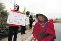  ?? Nikolas Samuels/The Signal ?? People protest outside of Congressma­n Steve Knight’s office on Carl Boyer Drive on Tuesday in Santa Clarita.