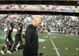  ?? GARY CAMERON — THE ASSOCIATED PRESS ?? Maryland interim head coach Matt Canada walks off the field with his squad after losing 24-3 to Michigan State on Saturday in College Park, Md. Canada faces an uncertain future, despite keeping the football team together and forging a winning record amid the chaos