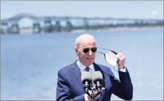  ?? Brenda Smialowski / AFP / TNS ?? President Joe Biden takes off his mask before speaking about infrastruc­ture and jobs along the banks of the Calcasieu River on Thursday in Westlake, Louisiana.