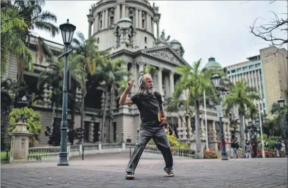  ??  ?? Preacher man: Gavin Mitchell (above), delivers his sermons in front of Durban’s City Hall (below left), a popular spot for protesters. Nearby is the Cenotaph garden (left). Both are shared daily by street people, office workers and councillor­s. Photos:...