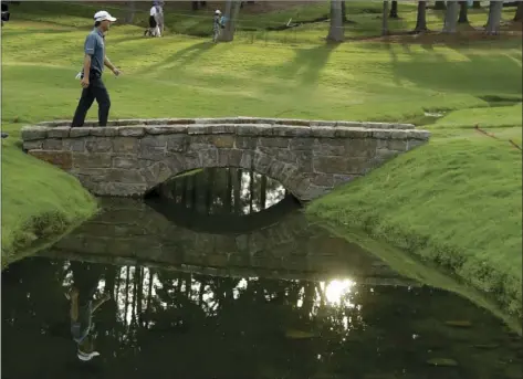  ?? PHOTO ?? Kevin Kisner walks across the bridge on the 18th hole during the third tournament at the Quail Hollow Club on Saturday in Charlotte, N.C. AP