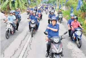  ?? — Gambar Bernama ?? TURUN PADANG: Zahid menunggang motosikal di sekitar Kampung Sungai Betul dan Kampung Pasang Api untuk ke rumah penerima Touch Point Baik Pulih Rumah NBOS-CTU Kementeria­n Komunikasi dan Multimedia Parlimen Bagan Datuk semalam.