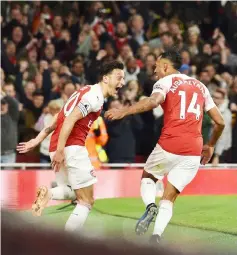  ??  ?? Arsenal’s Pierre-Emerick Aubameyang (right) celebrates with Mesut Ozil after scoring against Leicester City at the Emirates Stadium in London. — AFP photo