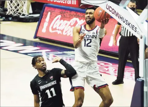  ?? David Butler II / Associated Press ?? UConn’s Tyler Polley (12) is fouled as he makes a basket against Providence.