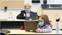  ?? AP PHOTO/TED S. WARREN ?? Students wear masks as they work in a fourth-grade classroom Tuesday at Elk Ridge Elementary School in Buckley, Wash. The school has had some students for in-person learning since September 2020, but other students are still learning remotely.