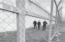  ?? AP/STR ?? Kosovo prison guards inspect the fence of the 300-cell prison in Gjilan, southeast of the capital of Pristina, Kosovo, where Denmark would run the new facility.