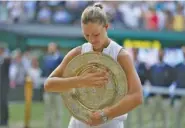  ?? THE ASSOCIATED PRESS ?? Angelique Kerber poses with her trophy after winning 6-3, 6-3 for her first Wimbledon championsh­ip.