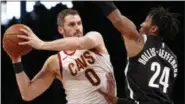  ?? KATHY WILLENS — ASSOCIATED PRESS ?? Kevin Love looks to pass as Nets forward Rondae HollisJeff­erson defends March 25 in New York.